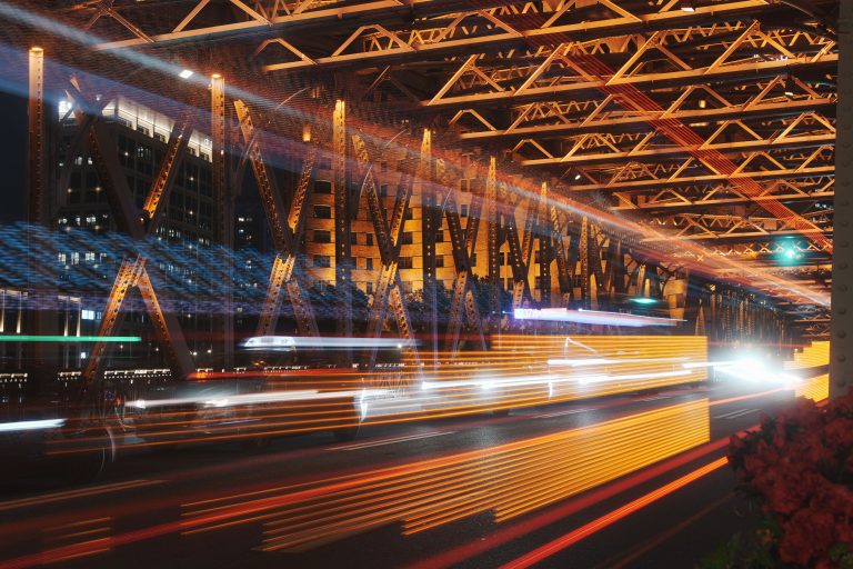 Autonomous Vehicle Insurance Expands as Texas Tightens Regulations 2 Commuters in an urban environment at night