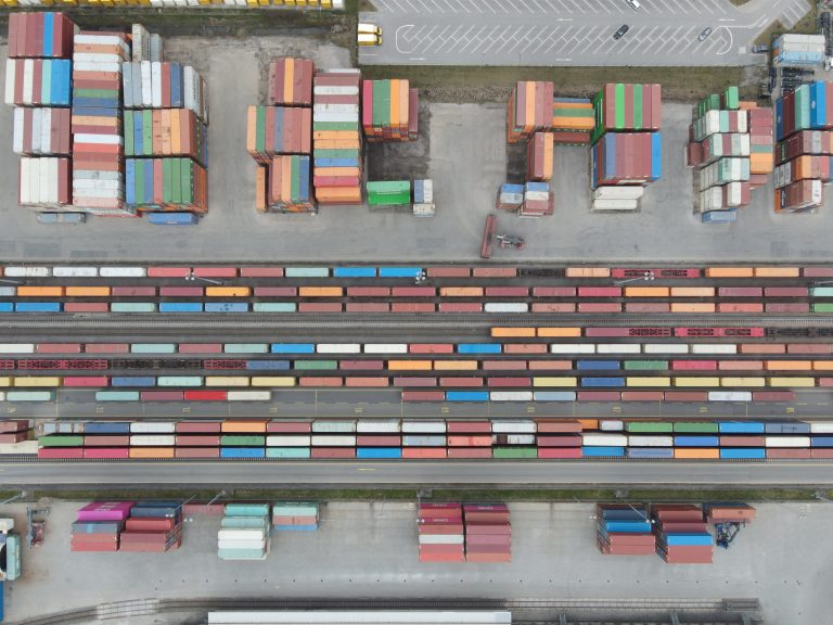 Tenet and Crown Merge to Bolster Freight Logistics Technology 1 Freight trucks and warehouse at a logistics hub