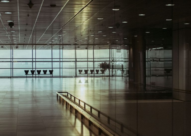 Sleeping Overnight at an Airport: Rules, Rest Options and What to Check 1 Empty rows of seats beside windows in an airport terminal