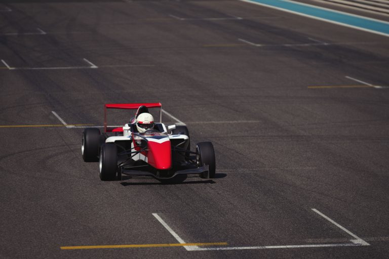 Dubai Tests Four-Week Glydways Autonomous Transit Trial 1 A formula race car speeds on the asphalt track at the iconic Abu Dhabi circuit