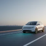 Sleek autonomous electric car on a clear lane with subtle sensor arcs, set against a soft, minimal city backdrop.