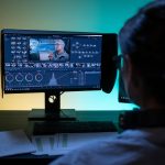 Technician managing AI-generated digital performers on screens