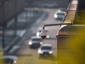 A roadside security camera overlooking passing traffic