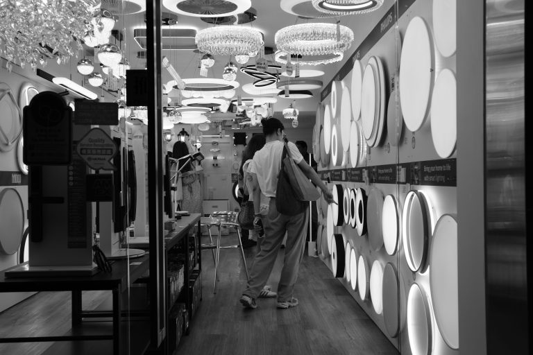 Monochrome view inside a Hong Kong lighting store, highlighting diverse fixtures and designs
