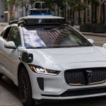 White autonomous car on a city street